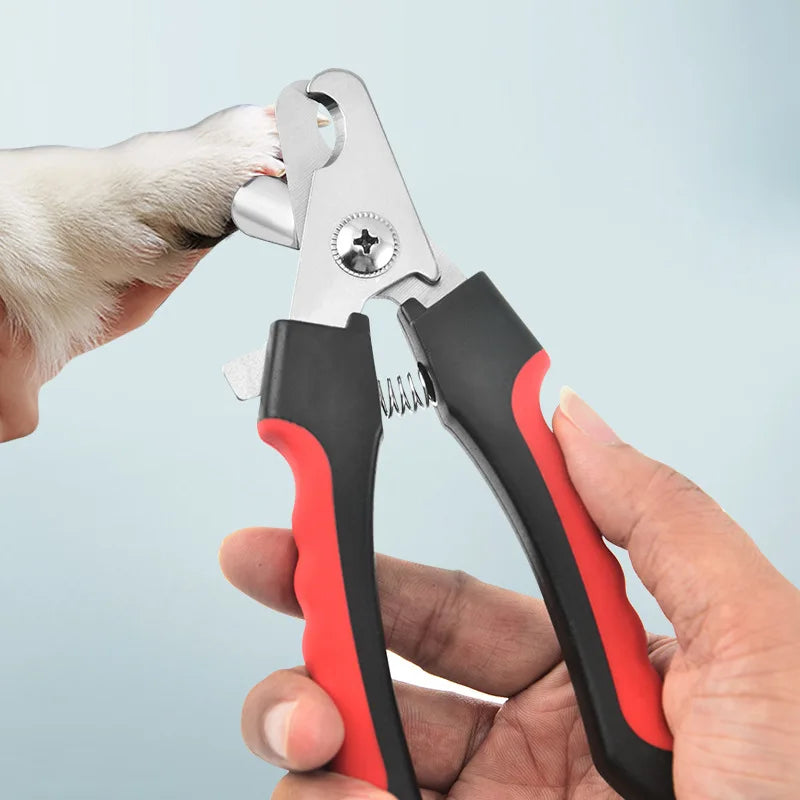 Pet nail clipper being used on a dog's paw with a light blue background