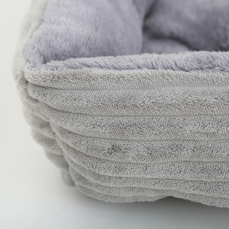 Grey washable small dog bed with cushioned sides and soft interior